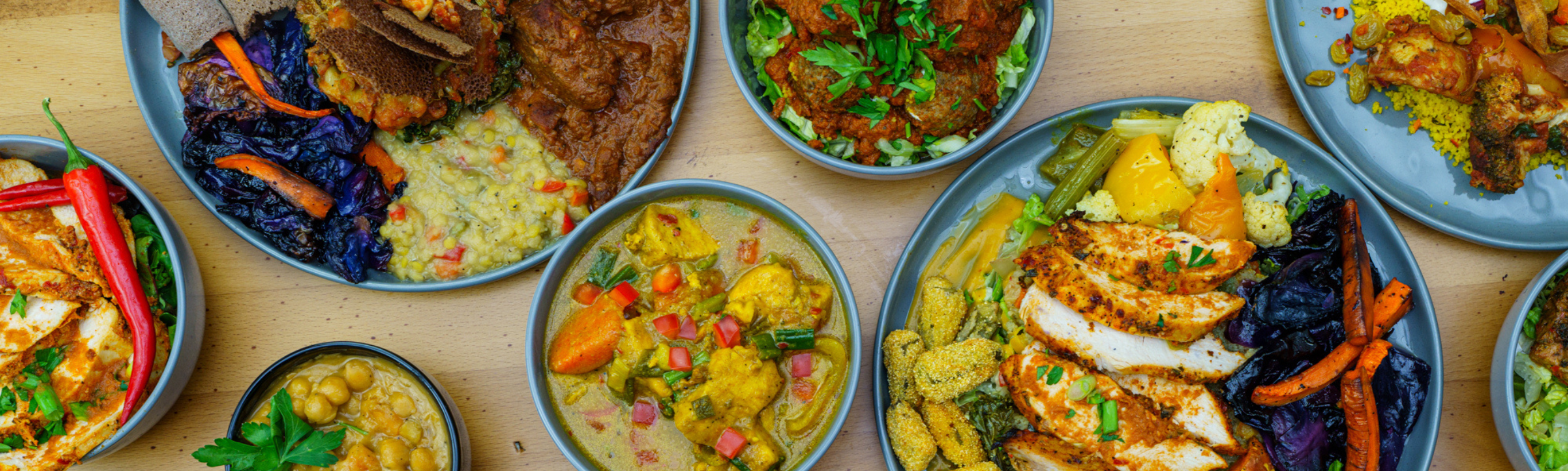 assortment of colorful vegetables meats and lentils