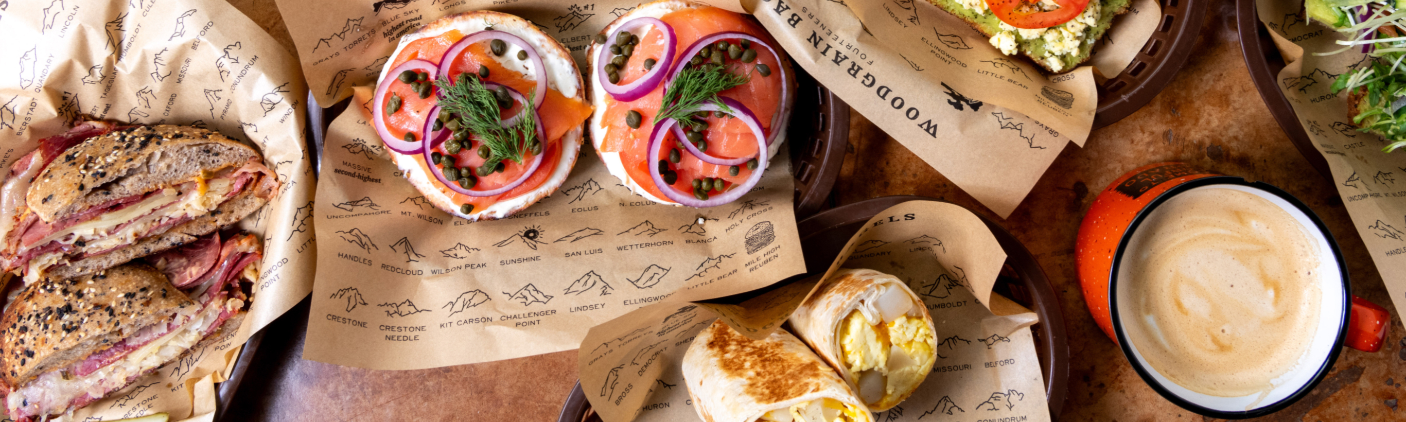Assortment of bagels, sandwiches, and coffee